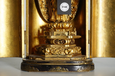 A Japanese lacquered and gilt wood "Zushi" shrine with a standing Buddha on a lotus throne, Edo, 17/18th C.